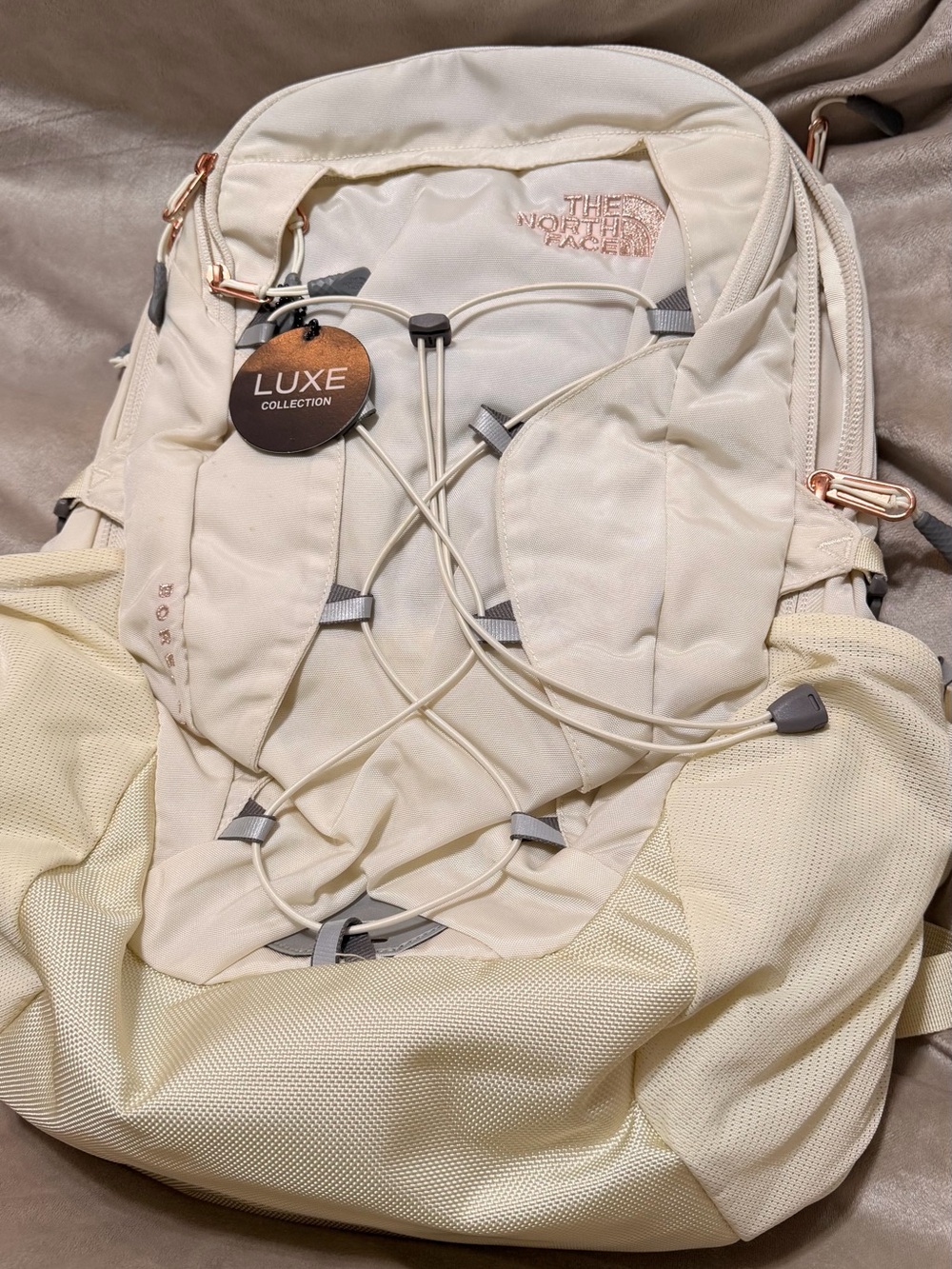 The North Face Luxe Collection Cream Backpack with Rose-Gold Accents